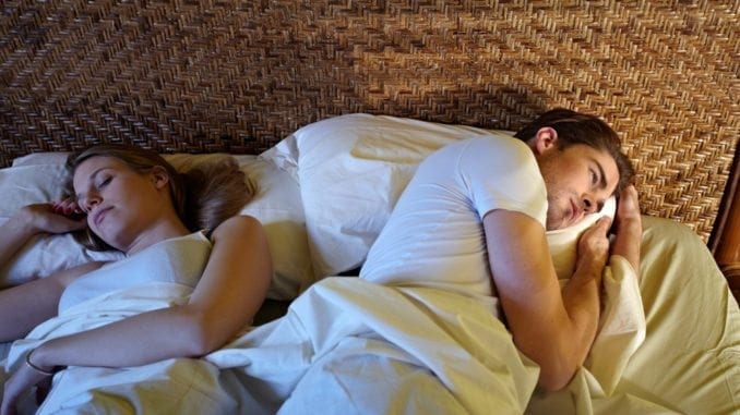 unhappy couple bed sleep problems