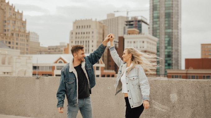 guy and girl dancing on roof