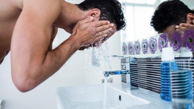 attractive man washing face