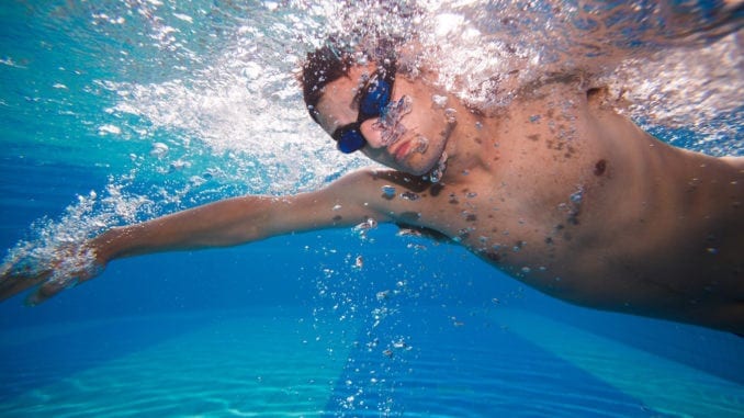 man swimming underwater athletic